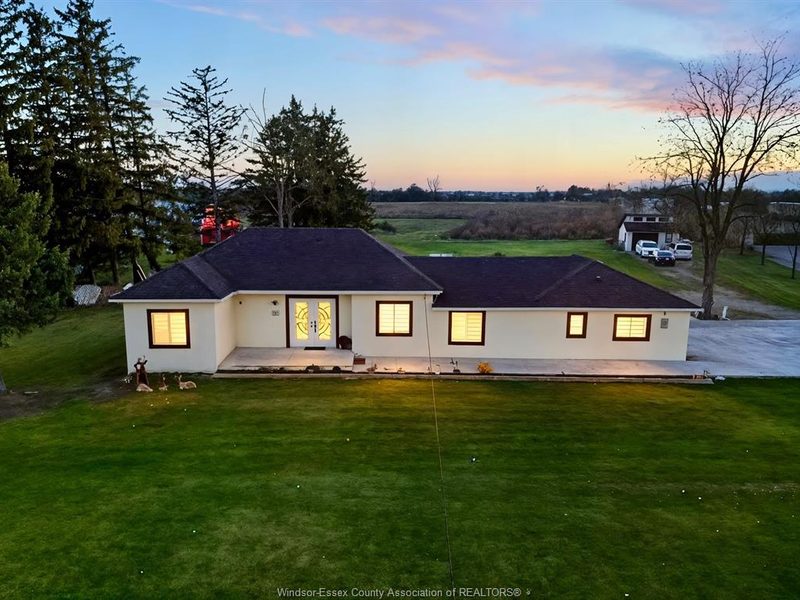 Renovated bungalow at 684 Talbot Road at dusk on a large lawn